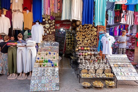Lively marketplace with colorful clothing and ceramics, traditional charm