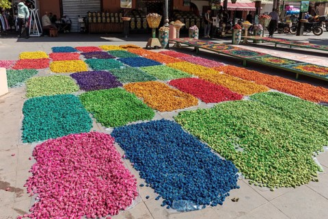 Colourful flower petals in creative patterns on an outdoor marketplace