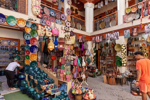 Lively market stall full of colorful pottery and traditional crafts