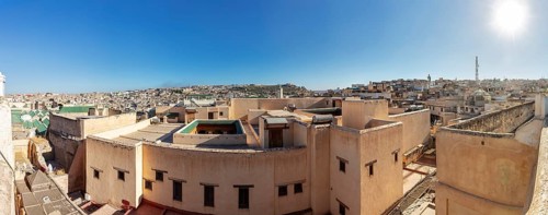 Panoramic view of the rooftops of a historic old town in strong sunlight