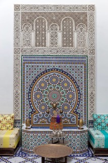 Richly decorated wall decoration with mosaics and traditional seating furniture