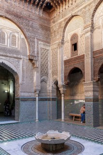 Detailed courtyard with geometric mosaics and round arches, quiet atmosphere
