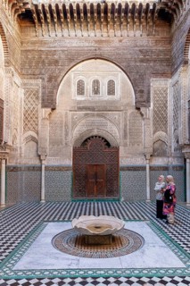 Traditional courtyard with ornate mosaics and a central water fountain