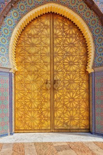 Close-up of an intricately carved and decorated palace door
