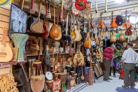 Interior view of a music store with many traditional instruments and customers