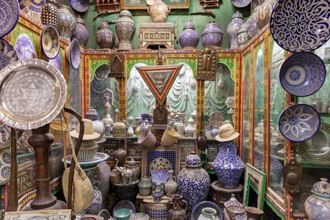 A bustling traditional market full of colorful ceramic ware and handmade pottery showcasing a rich