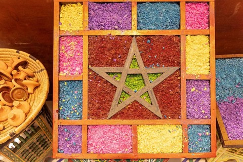 Vivid textile decor with a central star motif surrounded by a patchwork of colorful patterns