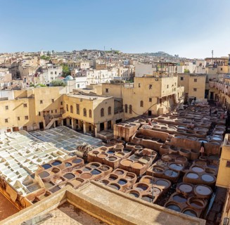 View of a traditional tannery in the old town of Fez under clear skies