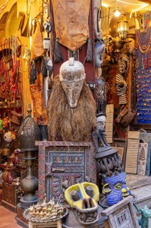 A shop full of colorful masks and tribal crafts with unusual decorations