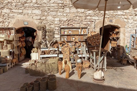 Handicraft market in an area surrounded by stone walls with traditional crafts and statues