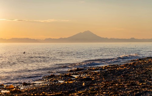 View of Cook Inlet on white mountain peaks of Mount Redoubt at sunset, midnight sun, Aleutian