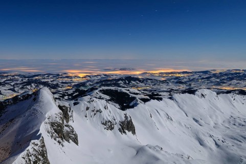 Night shot, long exposure of the 2506 meter high Säntis into the wintery, snow-covered, fog-covered