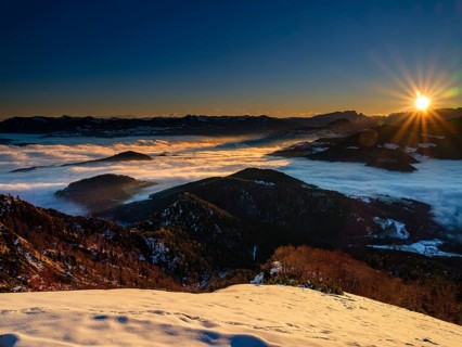 Alpine panorama at sunrise in winter, in the fog valley, Untersberg, Marktschellenberg,