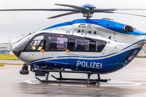 Helicopter from the Baden-Württemberg Police team in front of the hangar at the airport. Airbus