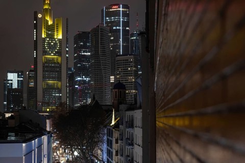 A yellow heart glows on the façade of the Commerzbank Tower in Frankfurt am Main at Christmas time