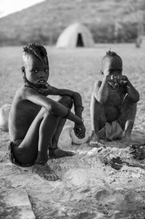 Black and white, Himba children at the fire early in the morning, traditional Himba village,