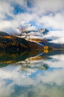Clouds of fog over Lake Sils with Piz da la Margna in the background, Upper Engadin, Canton of