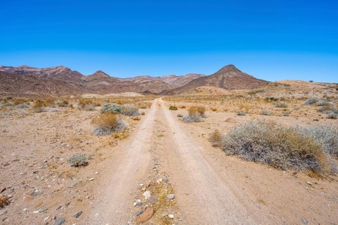 Sandy track through desert landscape with Brandberg, Erongo, Damaraland, Namibia