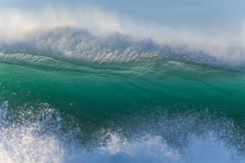 Perfectly constructed wave with turquoise colored sea water. Byron Bay, New South Wales, Australia