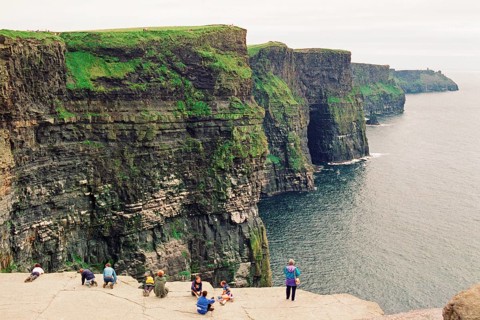 People on the cliff edge, there was no fence back then, Cliffs of Moher, County Clare, Republic of