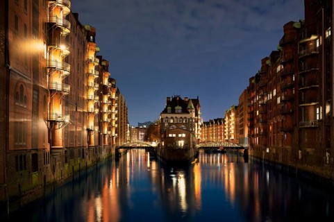 Night view, historic moated castle, warehouses, brick buildings, canal, Hamburger Speicherstadt,