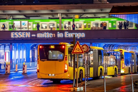 The main train station in Essen, blue illuminated underpass, bus station, am Europaplatz, train on