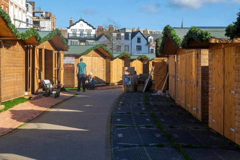 Wooden sheds being prepared for Exeter Cathedral Christmas Market, Exeter, Devon, England, UK