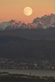 View from Horben of Lake Zug with the town of Cham and Zug, behind it the snow-capped mountains