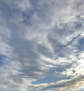 Cloud cover just in front of dusk with linear Altostratus clouds above it Cumulus mediocris with