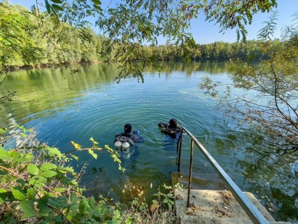 Recreational divers with diving equipment Diving tanks swim near the shore on the water surface of