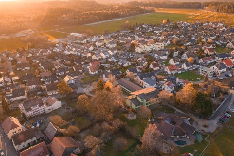 Village seen from the air in autumn twilight with surrounding fields, Althengstett, Calw district,