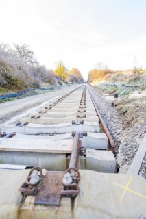 Straight tracks lead through an autumn landscape into fog, track construction of the Hermann Hesse