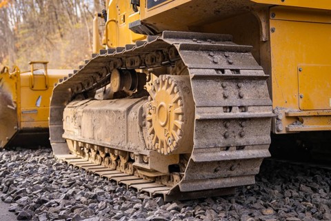 Close-up of a chain tractor on gravel, part of construction, track construction of the Hermann