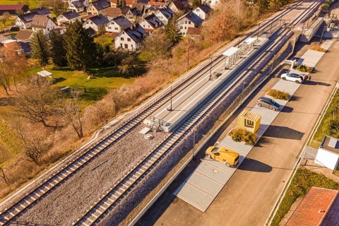 Station in the village with adjacent parking spaces and surrounding autumn landscape, new Hermann