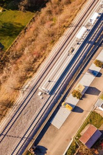 Railway line and platform in rural surroundings, with surrounding roads and vegetation, new Hermann