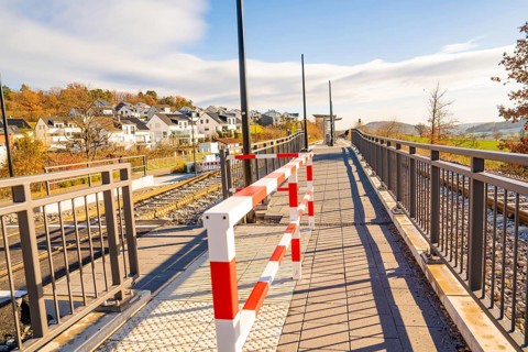 Footbridge with barrier in a modern environment, new Hermann Hessebahn railway station, Ostelsheim,