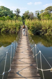 Toruist on the Kavango River, suspension bridge at Camp Kwando, Zambezi region, Caprivi Strip,