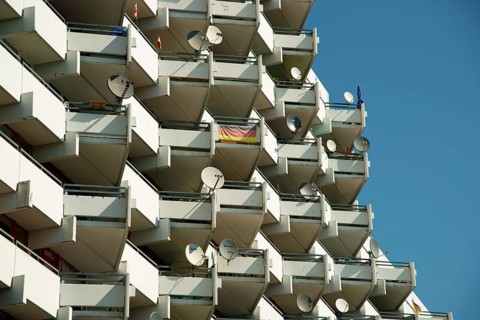High-rise apartment building with balconies and satellite dishes, satellite town of Chorweiler in