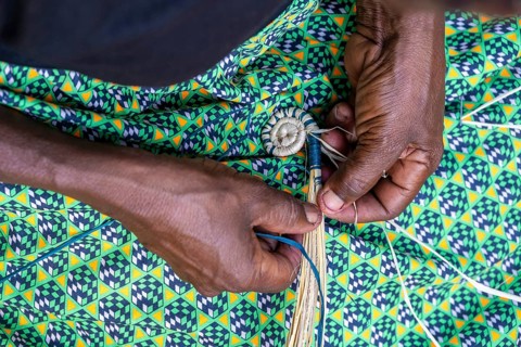 Local woman weaving baskets from papyrus, near Fort Portal, Uganda