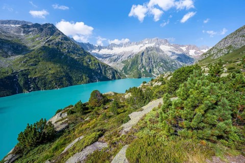 Turquoise blue mountain lake Göscheneralpsee, picturesque mountain landscape with dammastock and