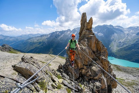 Crocodile rock formation, mountaineer on rope bridge in the Crocodile Mountain Lake via ferrata on