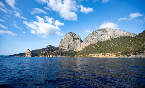Picturesque rocky coast, cliffs with Pedra Longa pinnacle, blue sea, Golfo di Orosei, Baunei,