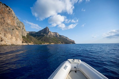 Motorboat trip along the picturesque rocky coast, cliffs and blue sea, Golfo di Orosei, Baunei,