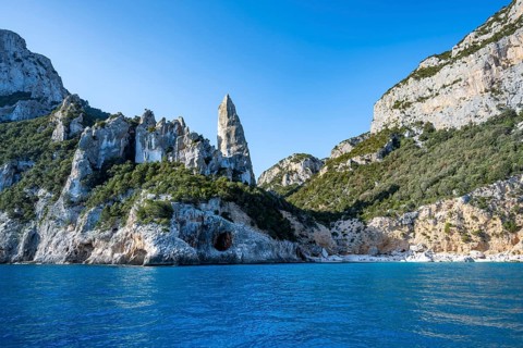 Picturesque rocky coast, cliffs with L'Aguglia pinnacle, blue sea and Cala Goloritzé beach, Golfo