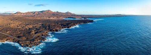 Coast with lava fields, volcanic landscape near Los Hervideros, in the evening light, aerial view,