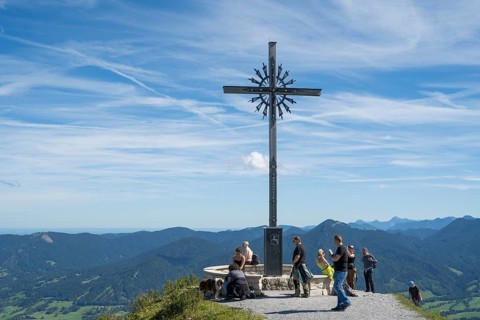 Summit cross with tourists, Brauneck 1555m, Bavarian Prealps, Isarwinkel, Lenggries, Upper Bavaria,