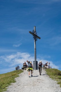 Summit cross with tourists, Brauneck 1555m, Bavarian Prealps, Isarwinkel, Lenggries, Upper Bavaria,