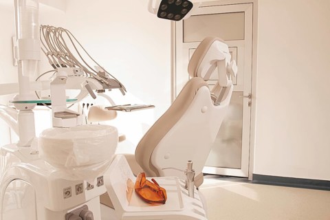 Modern dental clinic interior with equipment and patient chair ready for treatment