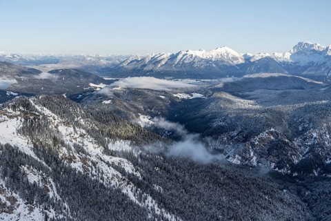 View of snow-covered mountain landscape across the Reintal towards the Estergebirge and