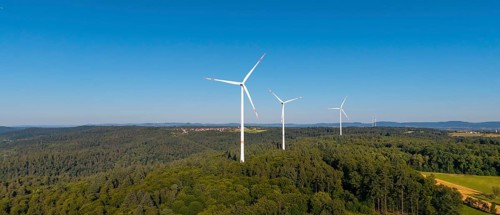 Wind turbines in a green hilly landscape, standing in a clear sky, near Schorndorf, Remstal,
